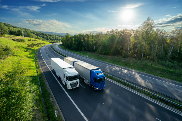 62fbbc3ee846b67820ed003f-two-trucks-driving