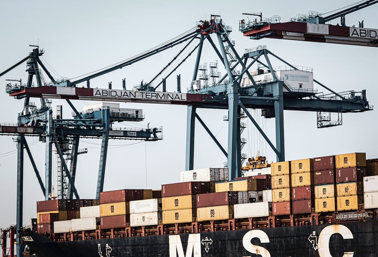 A view of large cranes and cargo containers at the busy Abidjan Terminal port.